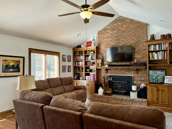 a living room with fireplace furniture and a flat screen tv