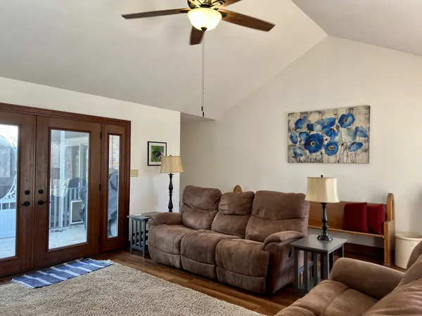 a view of a livingroom with furniture and hardwood floor