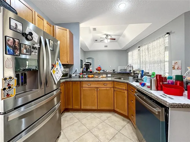 a kitchen with stainless steel appliances granite countertop a sink and cabinets