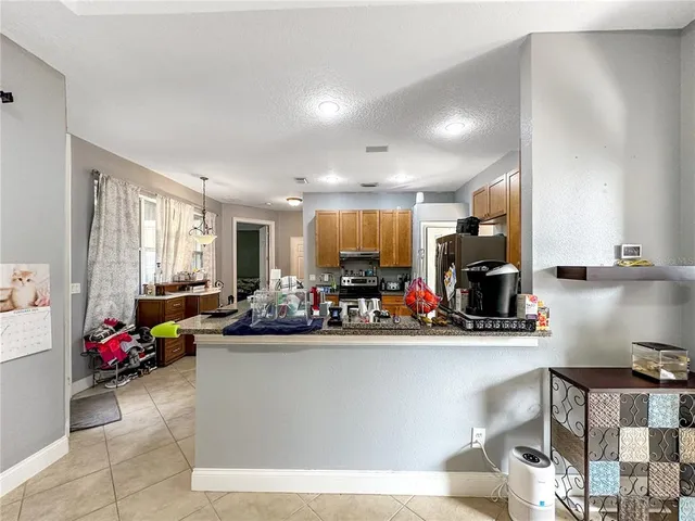 a spacious bedroom with a bed and a chandelier