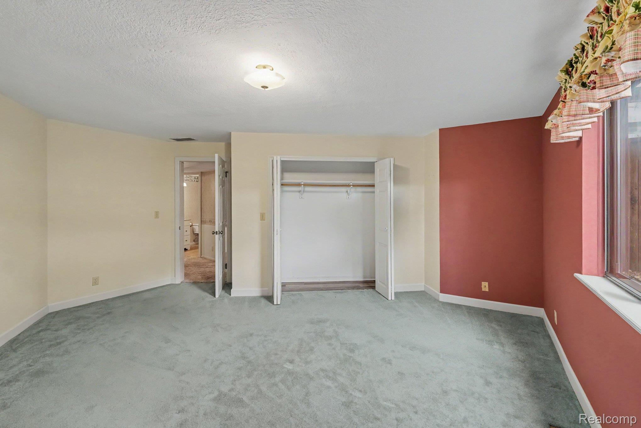 4425 North Henderson Road Davison, MI 48423 - Photo 24 of 43 Room featuring light blue carpet flooring and a neutral-toned ceiling