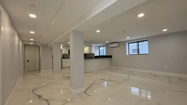 a view of a kitchen with a sink and a refrigerator