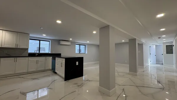 a kitchen with stainless steel appliances granite countertop a refrigerator and a stove