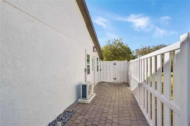 a view of a pathway of a house with wooden fence