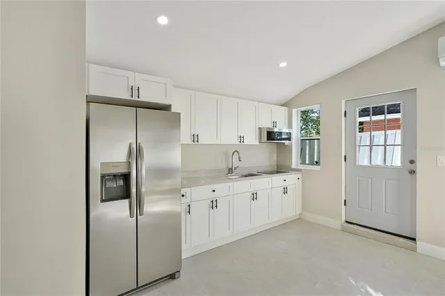 a kitchen with stainless steel appliances a refrigerator sink and cabinets