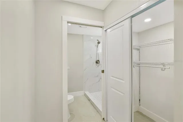 a bathroom with a shower and a glass door