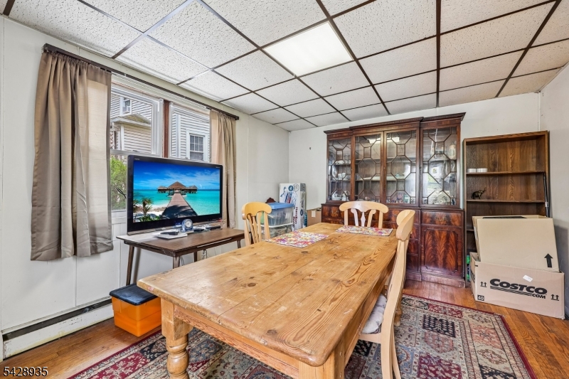 50 Preston Street Ridgefield Park, NJ 07660 - Photo 13 of 41 a living room with furniture a flat screen tv and floor to ceiling window