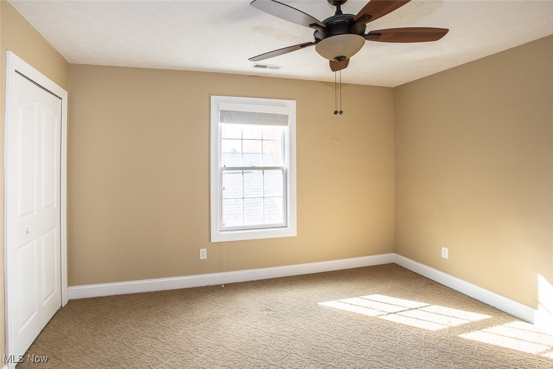 630 Rundle Street Lagrange, OH 44050 - Photo 28 of 49 Spare room with light carpet, ceiling fan, and a textured ceiling