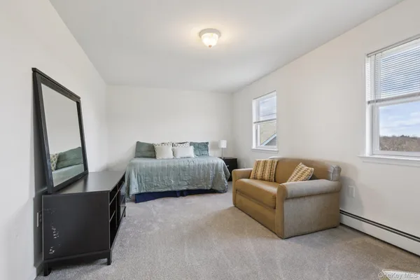 a bedroom with furniture and a window