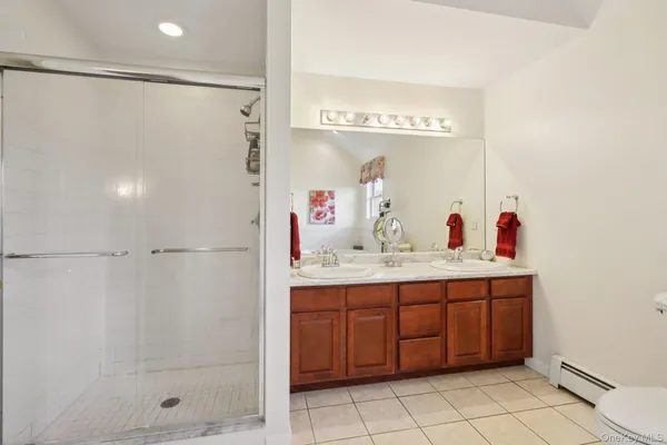 a bathroom with a shower sink and mirror