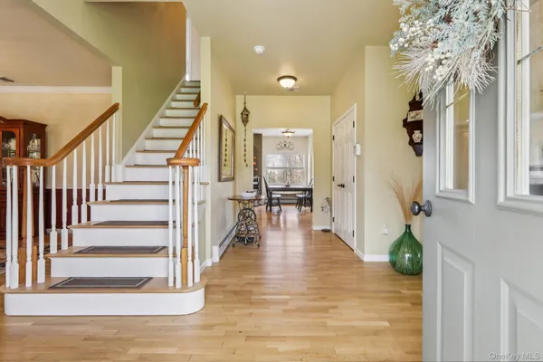 a view of entryway and hall with wooden floor