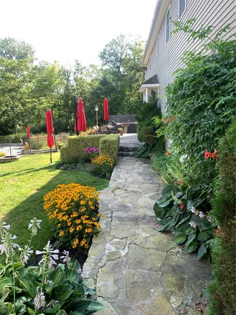 a view of a house with a backyard and swimming pool