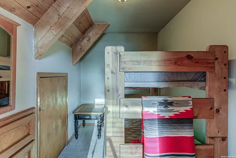 a bedroom with a bunk bed and a dresser
