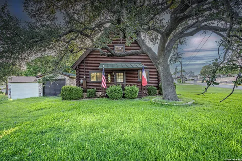 a front view of a house with yard and green space