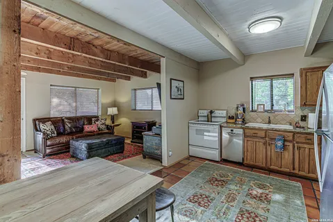 a living room with granite countertop furniture and a kitchen