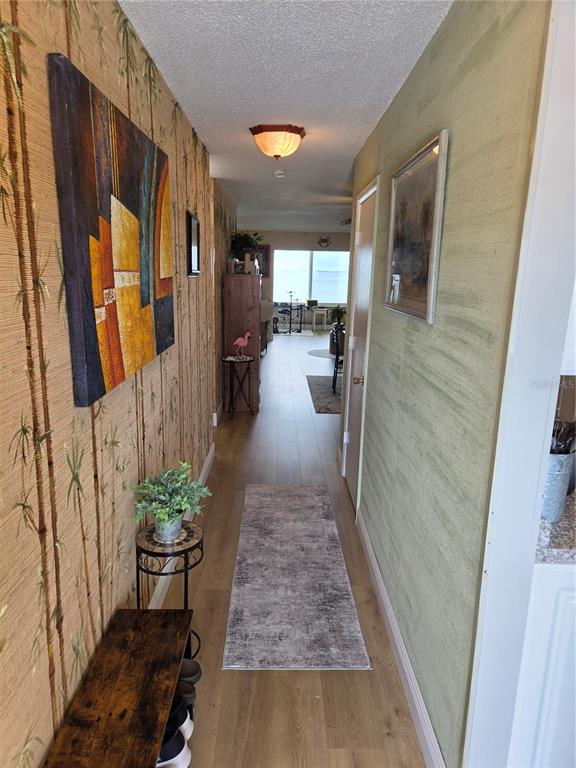7 Dunoon Place, Unit 309 Dunedin, FL 34698 - Photo 16 of 25 a hallway with a table and chairs