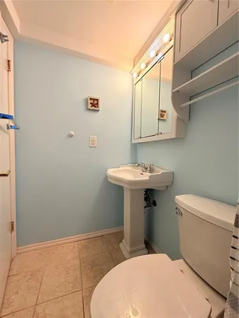 a bathroom with a sink a toilet and mirror
