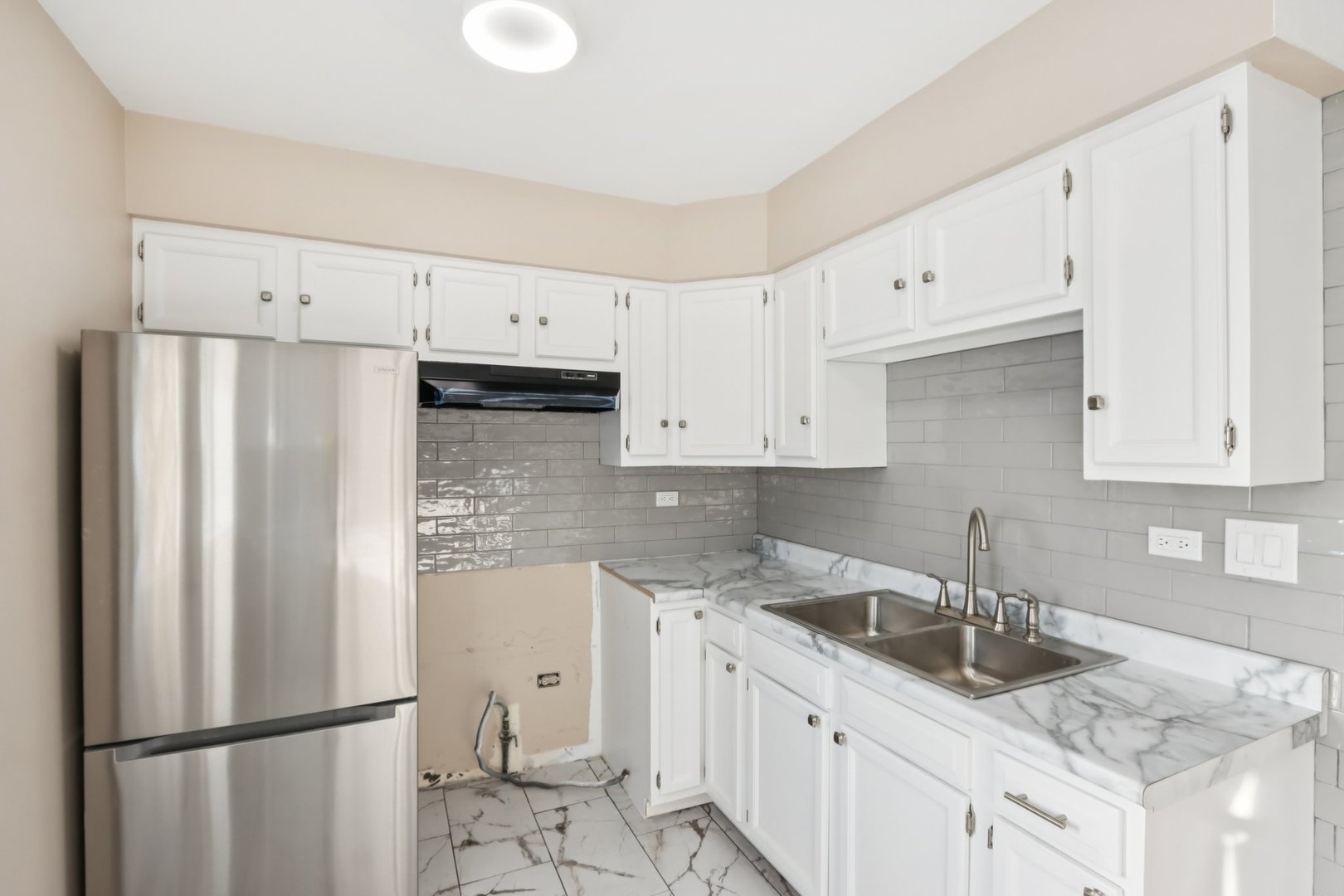 26814 North Genesee Street Wauconda, IL 60084 - Photo 13 of 34 a kitchen with stainless steel appliances granite countertop a refrigerator sink and white cabinets