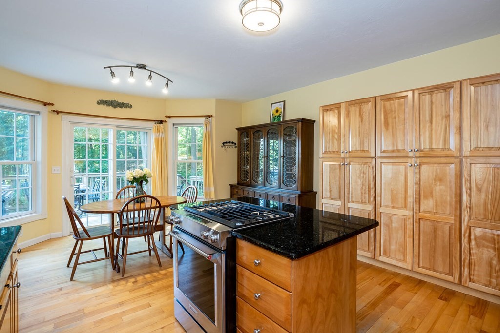 150 East Leverett Road Amherst, MA 01002 - Photo 17 of 42 a kitchen with granite countertop a stove dining table and chairs