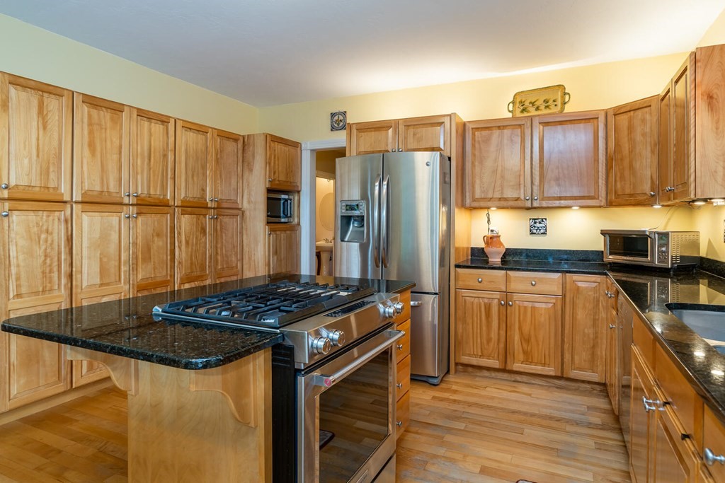 150 East Leverett Road Amherst, MA 01002 - Photo 18 of 42 a kitchen with stainless steel appliances granite countertop a stove refrigerator sink and cabinets