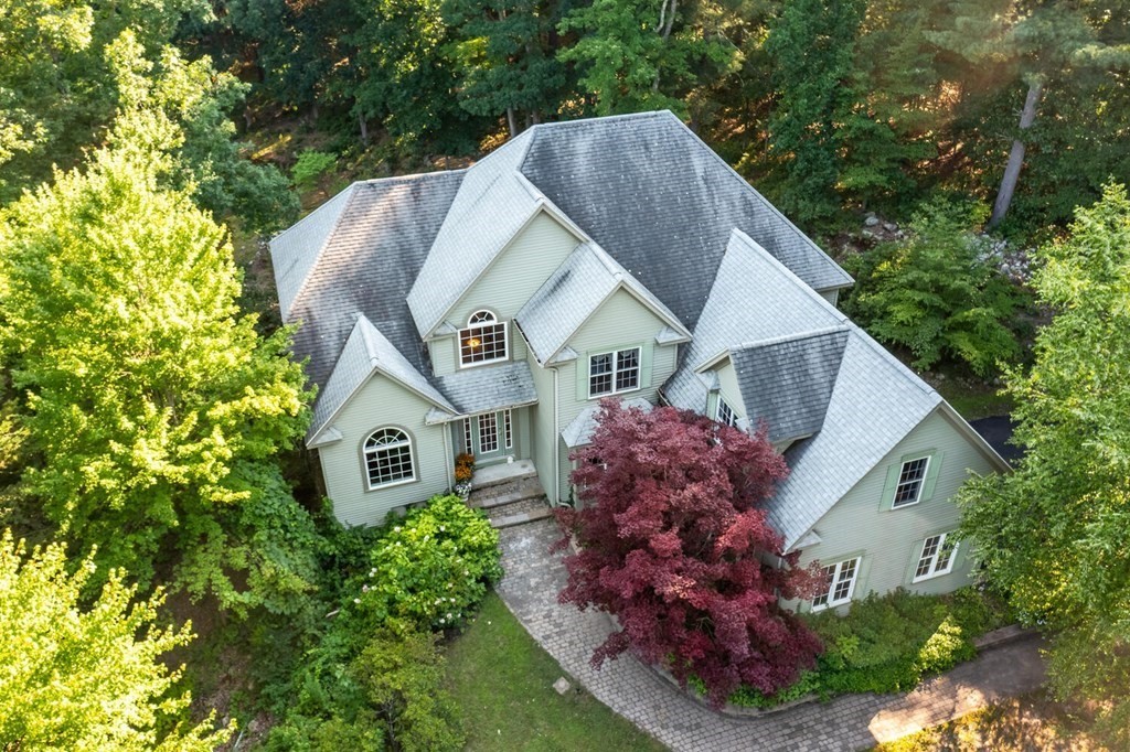 150 East Leverett Road Amherst, MA 01002 - Photo 2 of 42 a house with lots of trees in the background