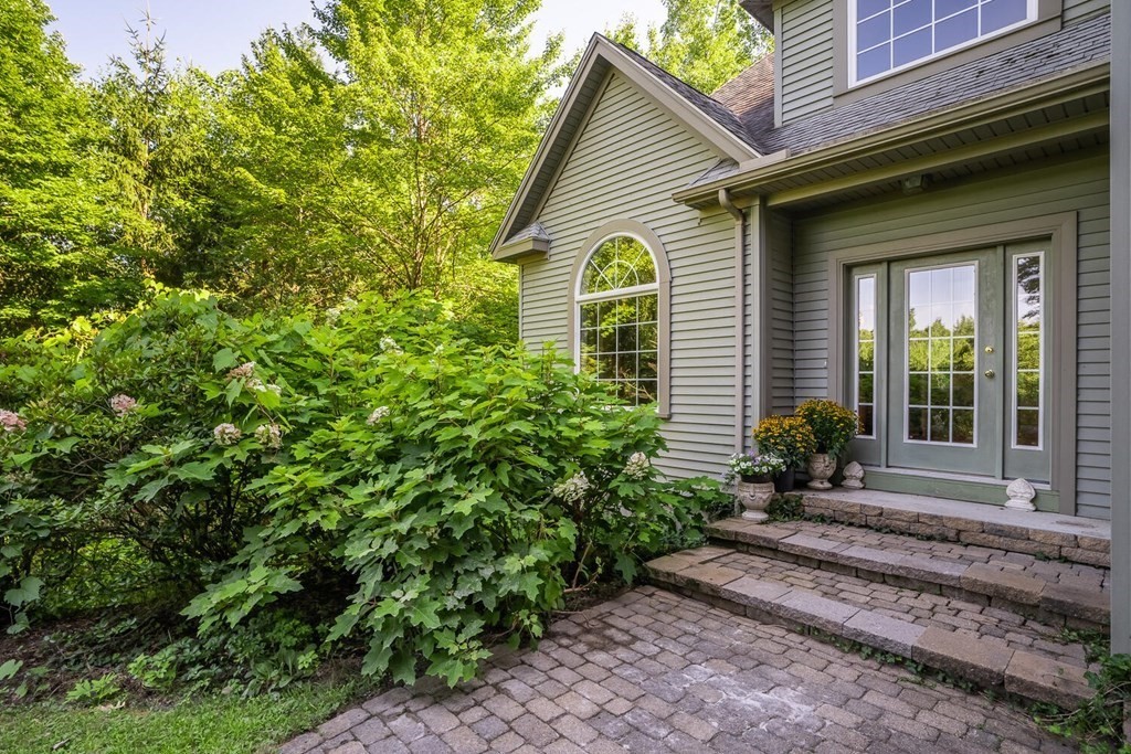 150 East Leverett Road Amherst, MA 01002 - Photo 3 of 42 a view of a house with a small yard plants and large tree