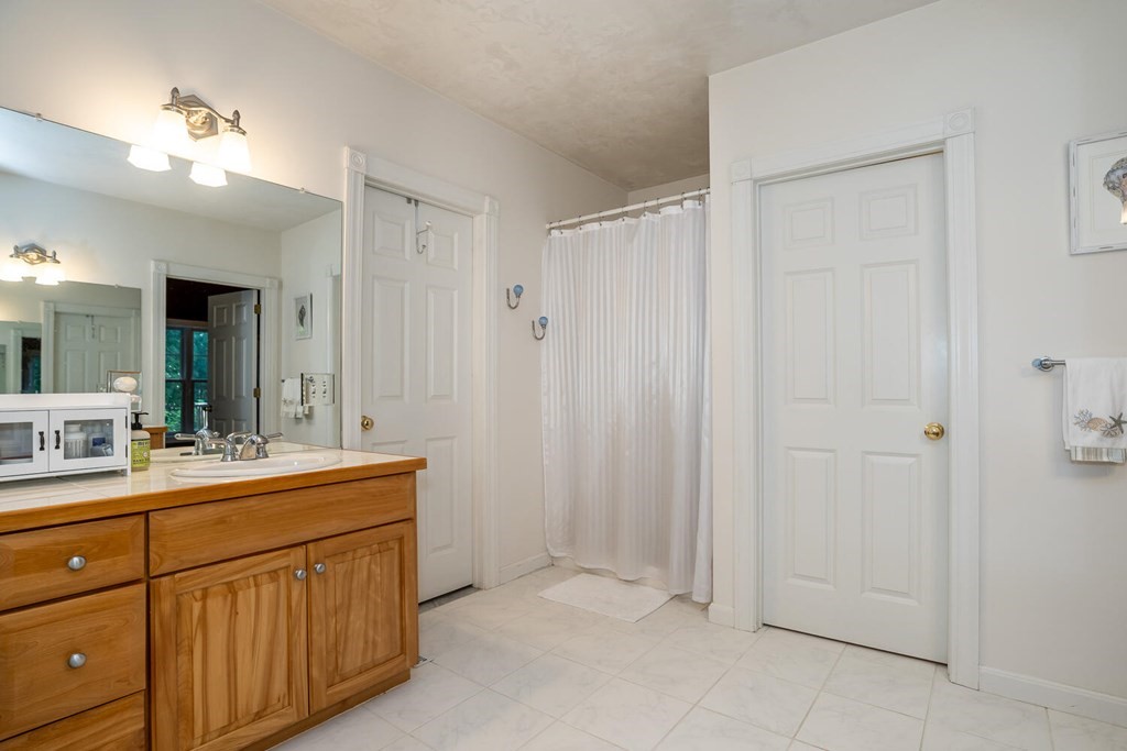 150 East Leverett Road Amherst, MA 01002 - Photo 33 of 42 a bathroom with a double vanity sink mirror and