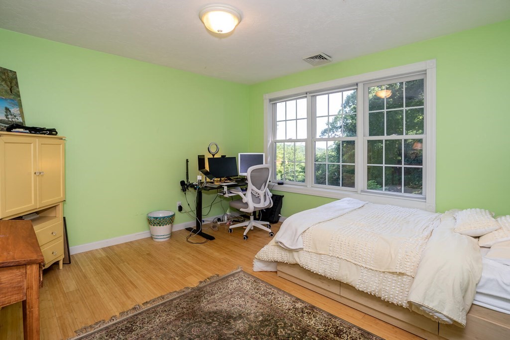 150 East Leverett Road Amherst, MA 01002 - Photo 35 of 42 a bed sitting in a bedroom next to a window