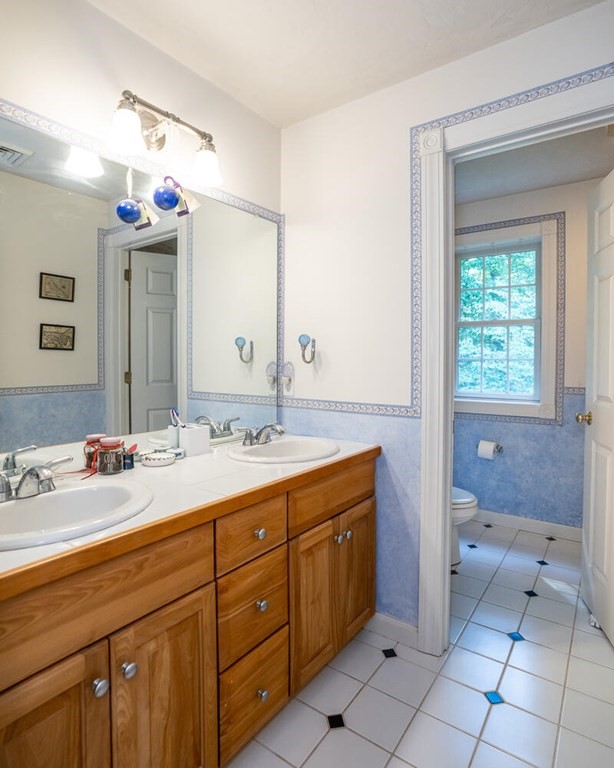 150 East Leverett Road Amherst, MA 01002 - Photo 40 of 42 a bathroom with a sink double vanity and a mirror