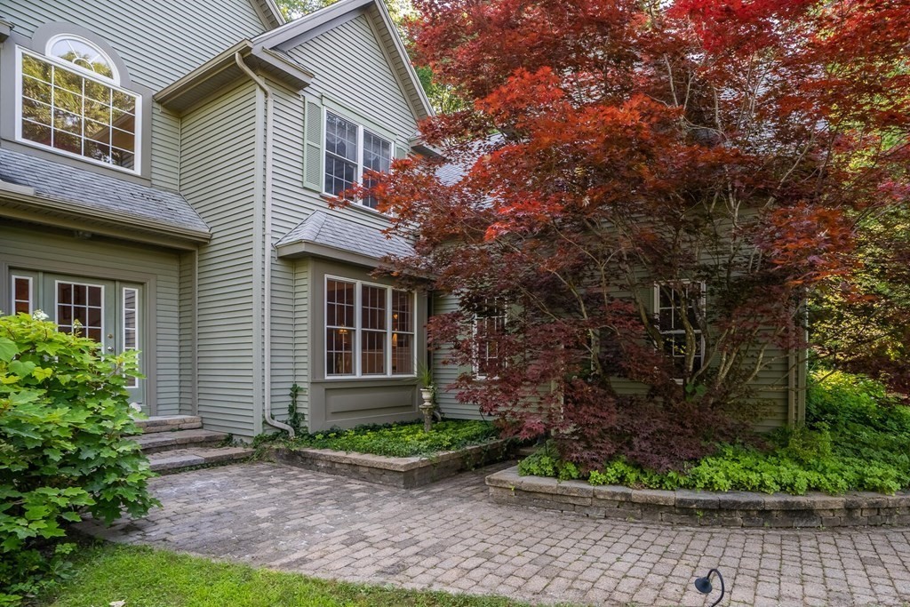 150 East Leverett Road Amherst, MA 01002 - Photo 4 of 42 a front view of a house with a yard and potted plants
