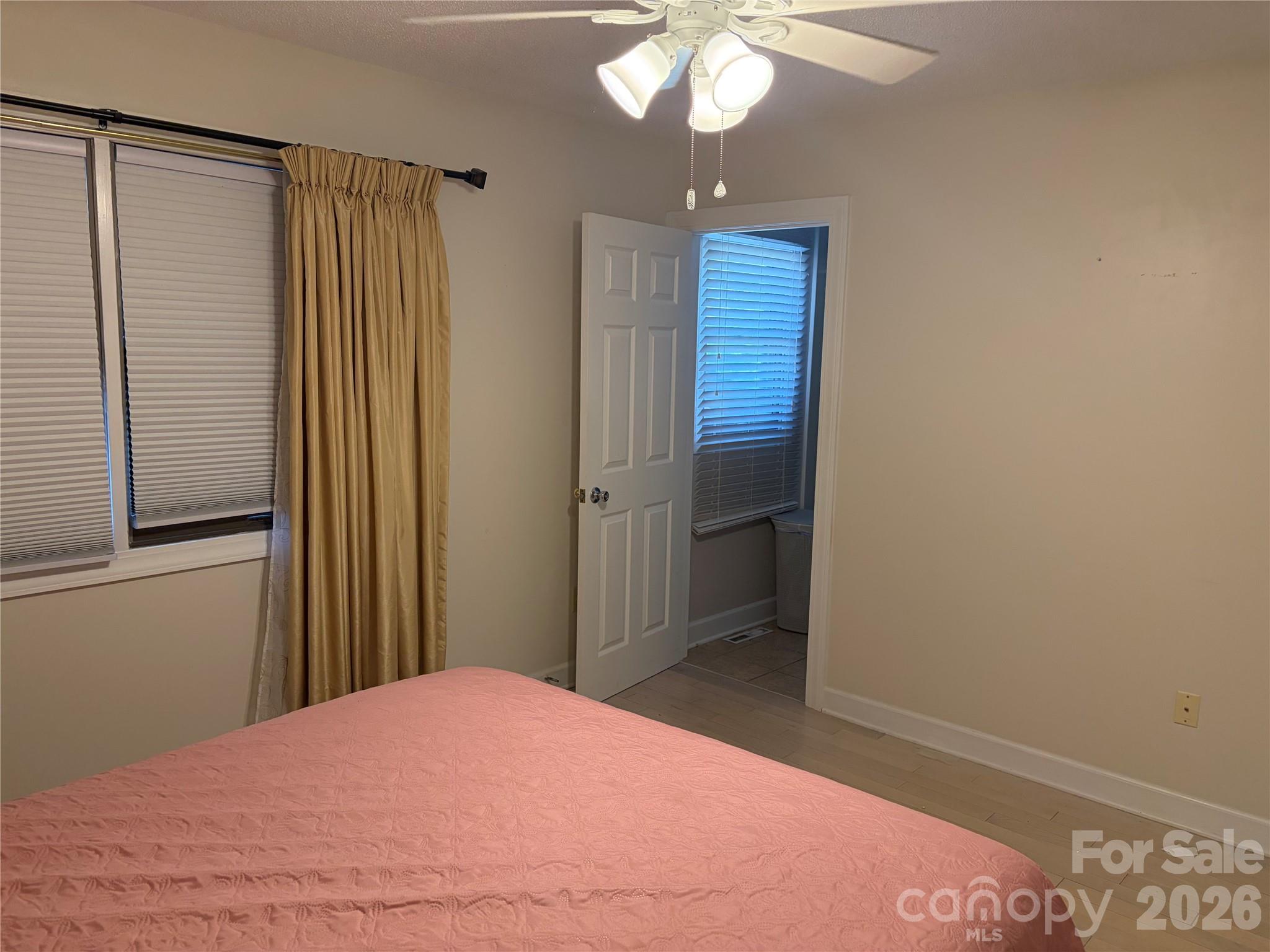 256 A Bruce Road Mars Hill, NC 28754 - Photo 30 of 39 a bedroom with a bed and a chandelier