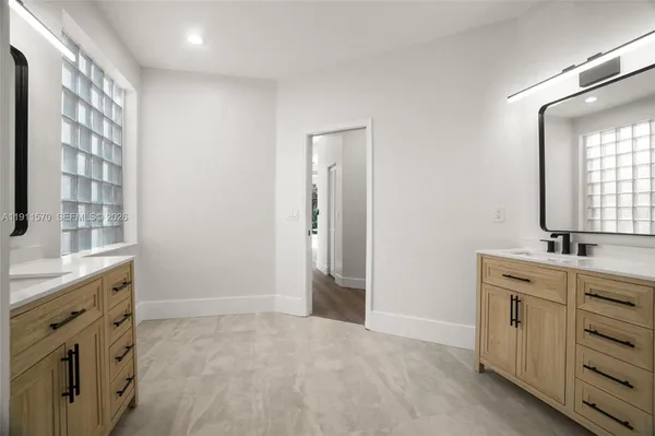 a bathroom with a double vanity sink mirror and