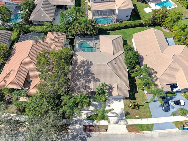 an aerial view of a house with yard swimming pool and outdoor seating