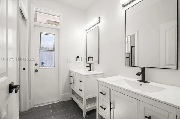 a bathroom with a double vanity sink mirror and