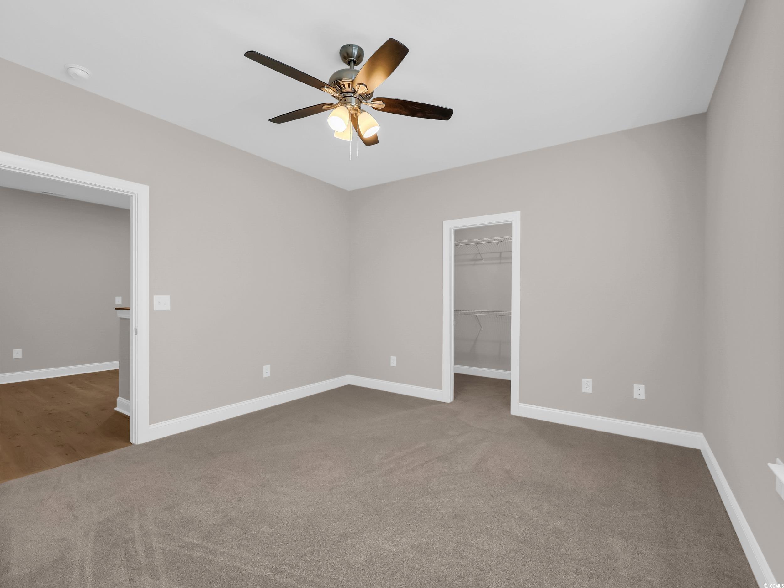 344 Kiskadee Loop Conway, SC 29526 - Photo 13 of 23 Unfurnished bedroom featuring light carpet, a walk in closet, and ceiling fan