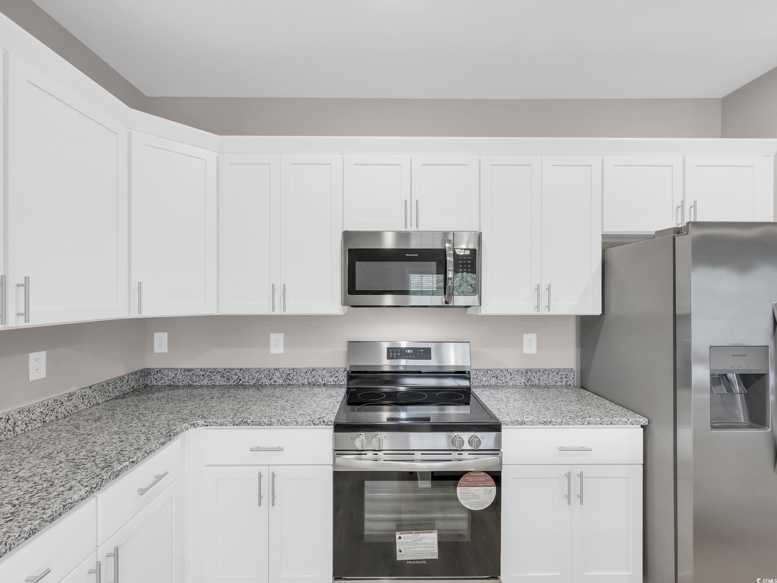 344 Kiskadee Loop Conway, SC 29526 - Photo 6 of 23 Kitchen with appliances with stainless steel finishes, white cabinetry, and light stone countertops