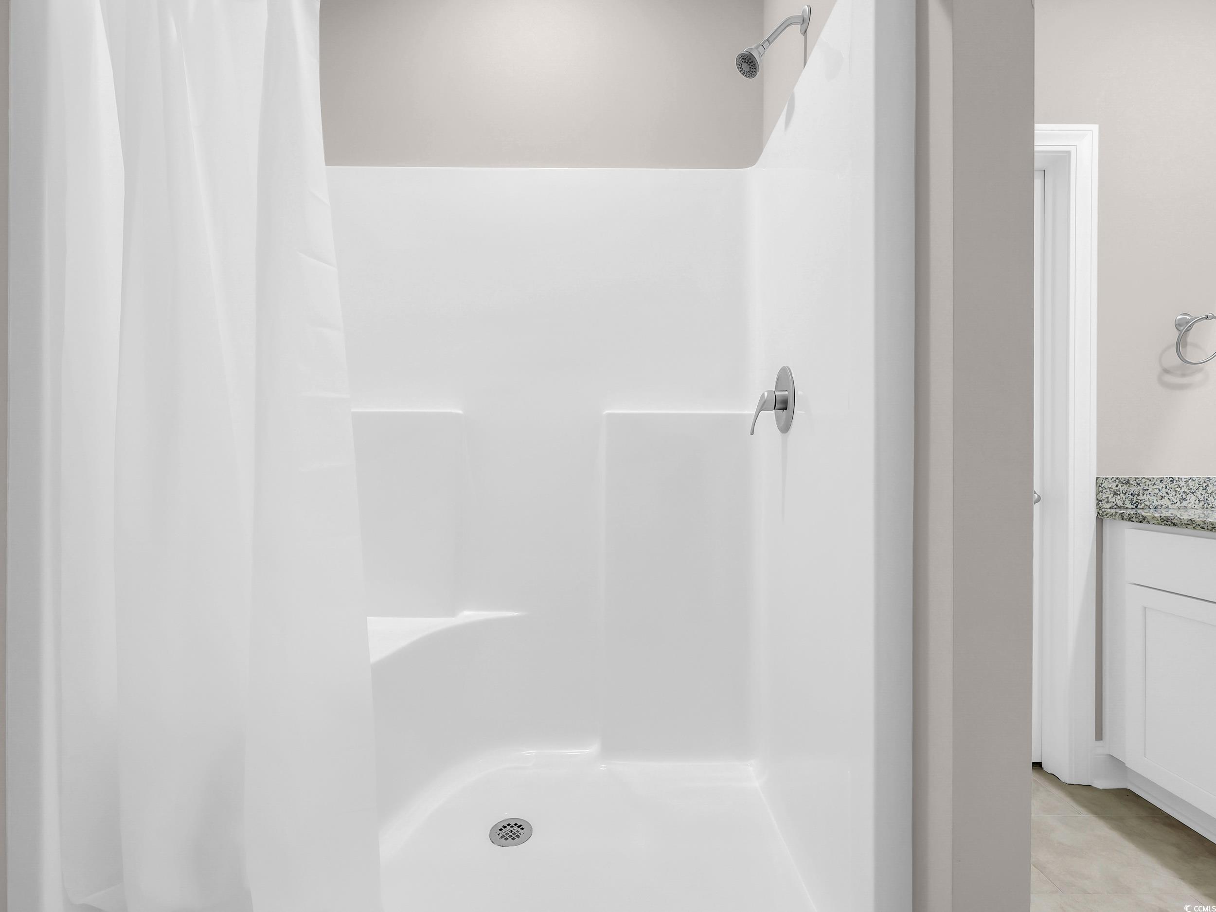 344 Kiskadee Loop Conway, SC 29526 - Photo 10 of 23 Full bath featuring a shower stall, vanity, and light tile patterned floors