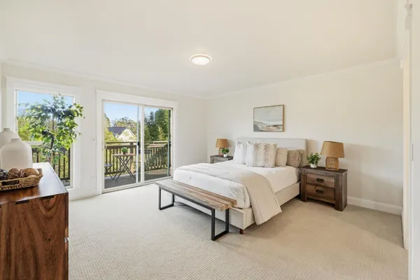 a bedroom with a bed and a large window