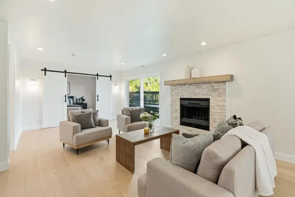 a living room with furniture and a wooden floor