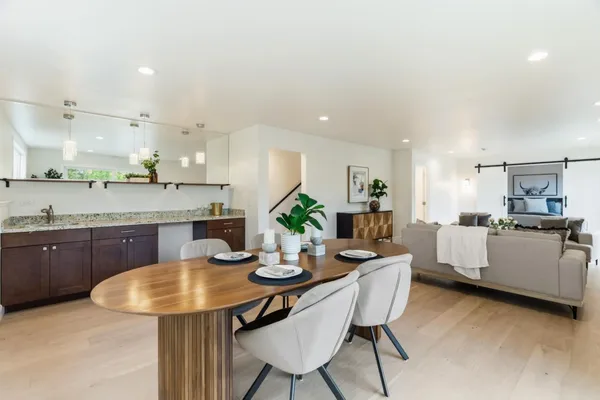 a kitchen with stainless steel appliances a stove a refrigerator and a white cabinets