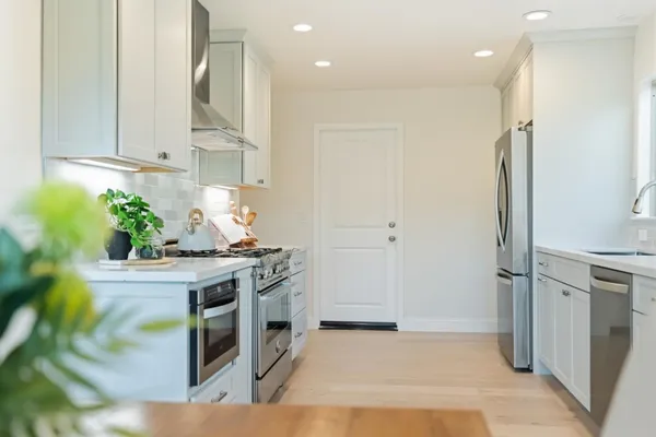 a bedroom with a bed and painting on the wall