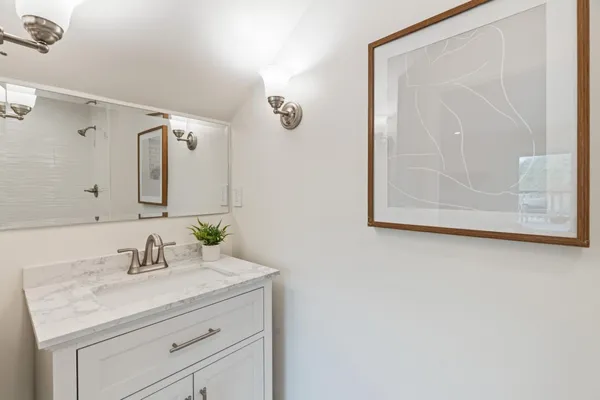 a bedroom with a bed and a potted plant