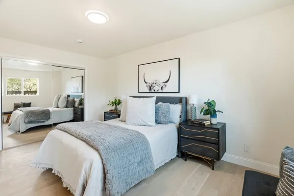 a bedroom with a large bed and a window