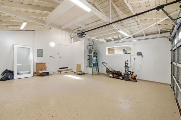 a view of a house with a wooden fence