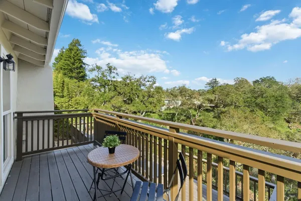 a view of a house with barbeque oven and sitting area