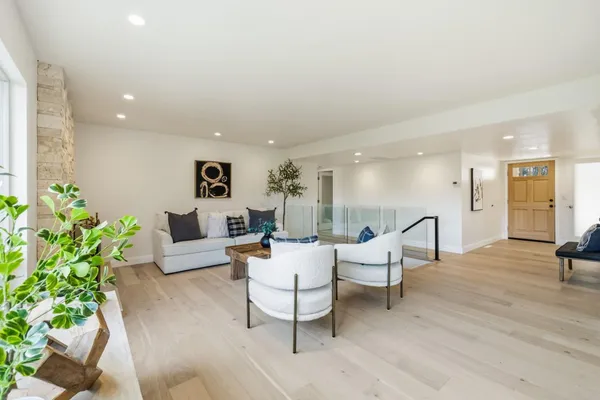 a living room with furniture and a floor to ceiling window