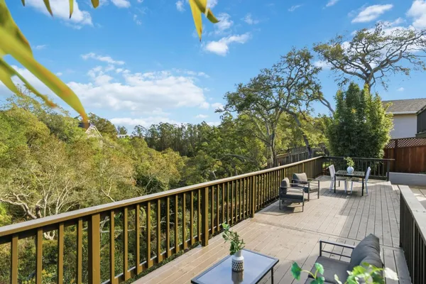 a view of a white house with iron fence