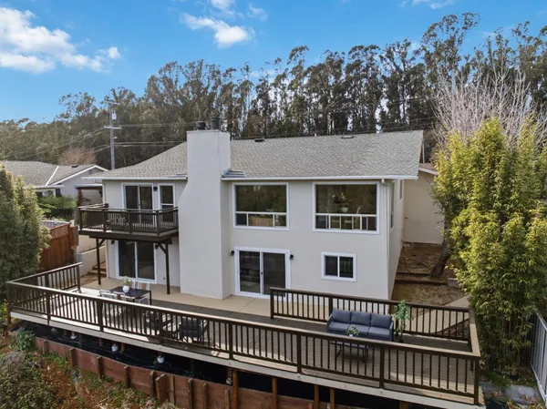 a balcony with wooden floor and furniture