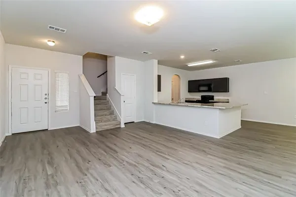 a view of kitchen with microwave and wooden floor