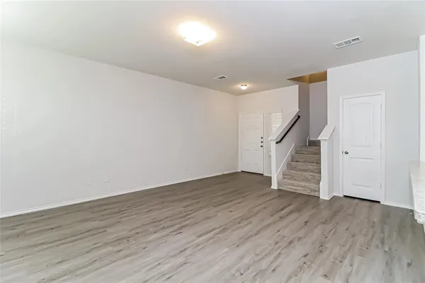 wooden floor in an empty room with stairs